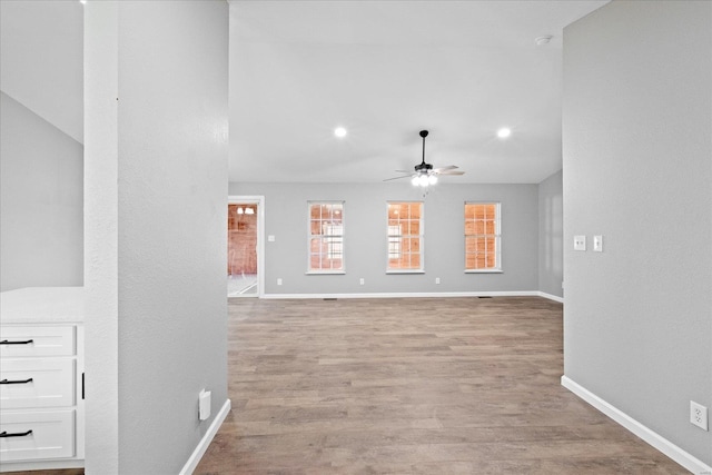 interior space with ceiling fan and light hardwood / wood-style flooring