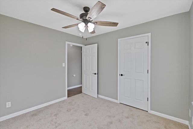 unfurnished bedroom featuring ceiling fan and light carpet