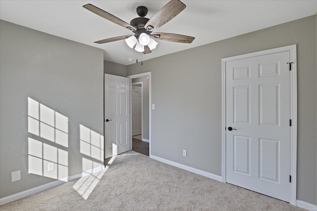 unfurnished bedroom with ceiling fan and light carpet