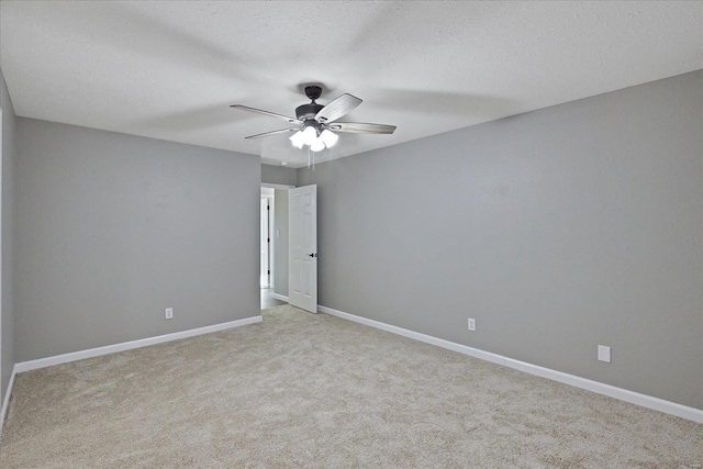 carpeted spare room with ceiling fan and a textured ceiling