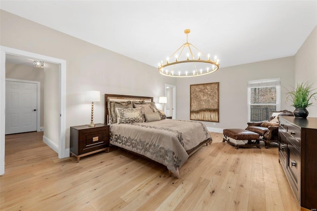 bedroom with a chandelier and light wood-type flooring