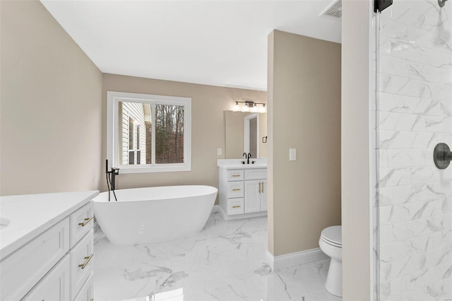 bathroom with a bath, vanity, and toilet