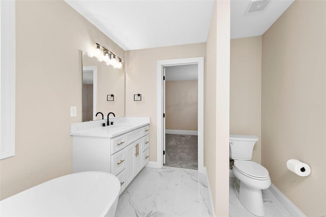 bathroom with vanity, toilet, and a bathtub