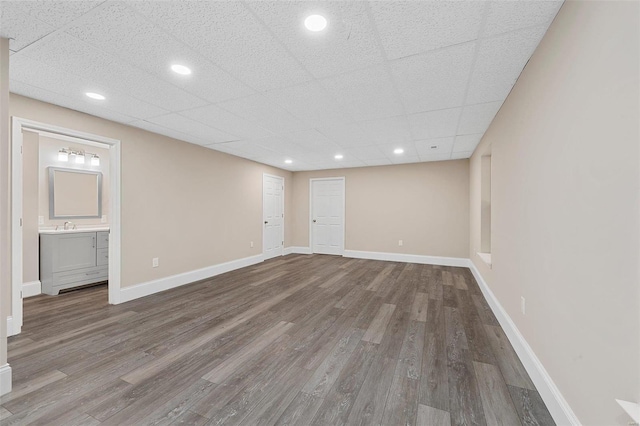 interior space with hardwood / wood-style flooring and a paneled ceiling