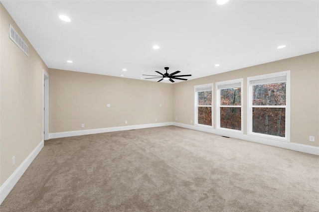 carpeted empty room featuring ceiling fan