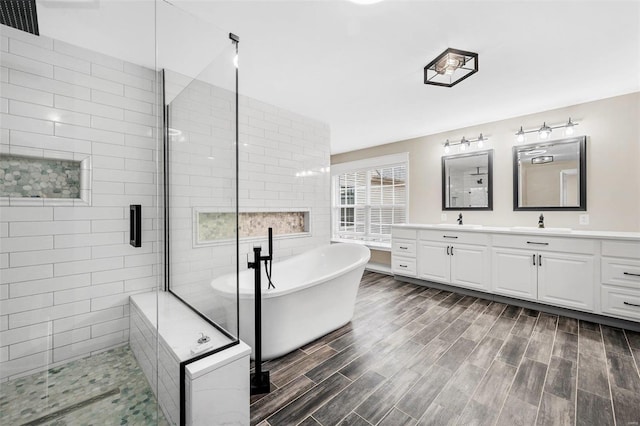 bathroom featuring vanity and independent shower and bath