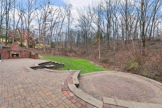 view of patio / terrace featuring exterior fireplace