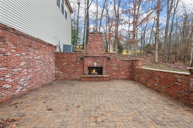 view of patio with an outdoor brick fireplace