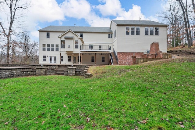 rear view of house featuring a yard and a wooden deck