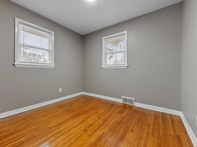 empty room with hardwood / wood-style flooring