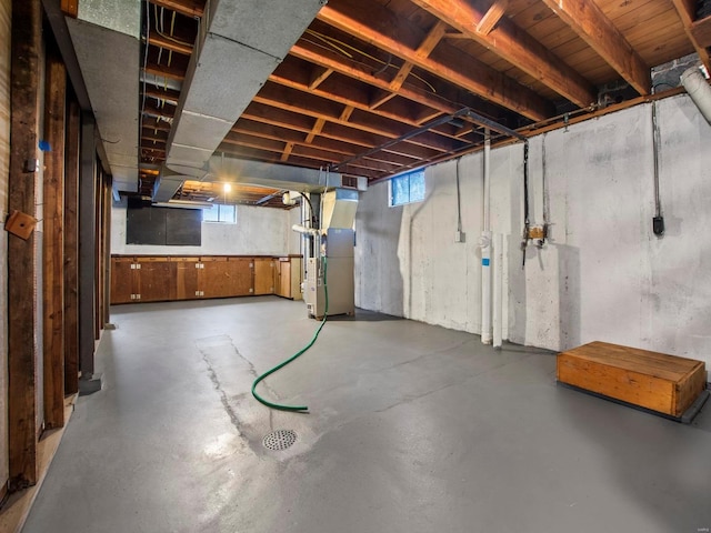 basement featuring heating unit and a healthy amount of sunlight