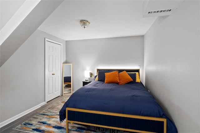 bedroom with dark wood-type flooring