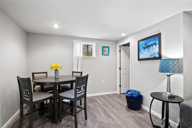 dining space with hardwood / wood-style flooring