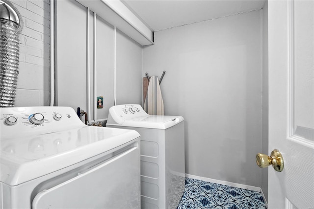 laundry area with light tile patterned floors and separate washer and dryer