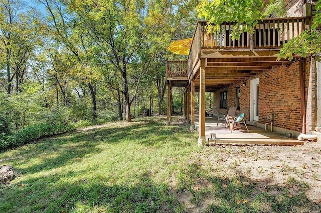 view of yard featuring a patio and a wooden deck