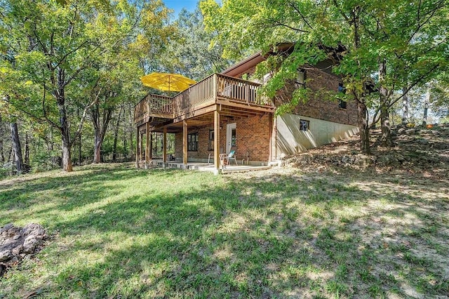 back of property featuring a lawn and a wooden deck