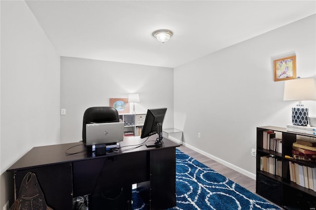 home office with dark hardwood / wood-style floors