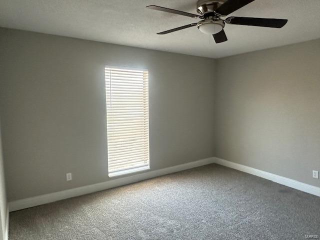 carpeted empty room with ceiling fan