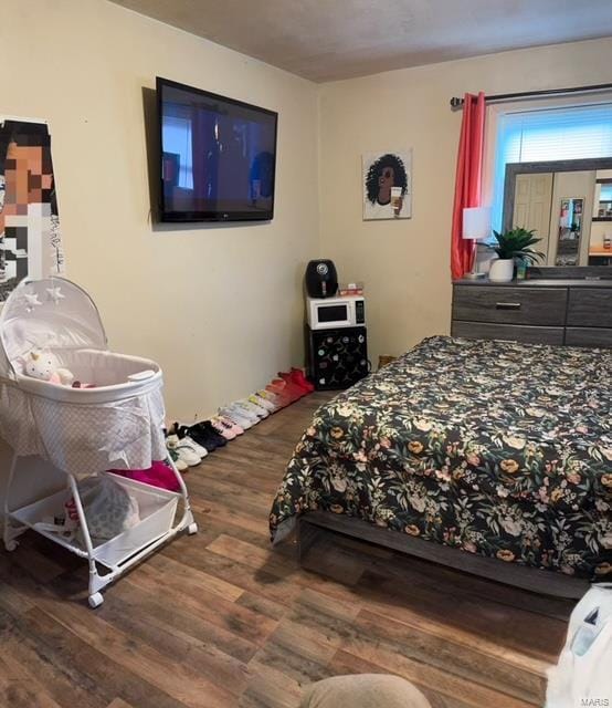 bedroom with hardwood / wood-style floors