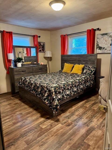 bedroom with wood-type flooring