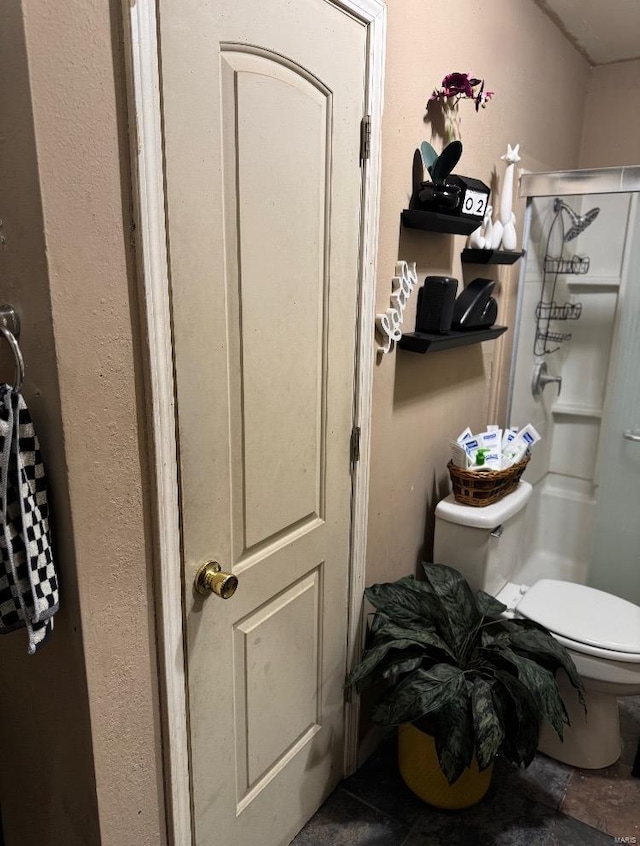 bathroom with a shower and toilet