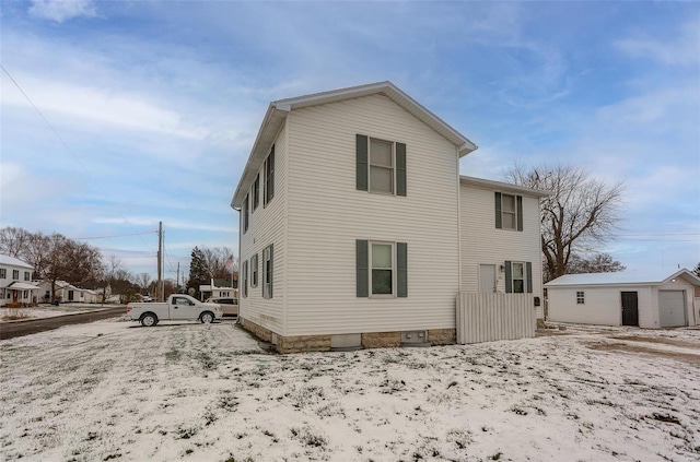 rear view of property with an outbuilding