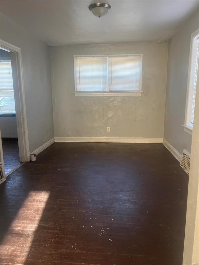 spare room featuring dark wood-type flooring