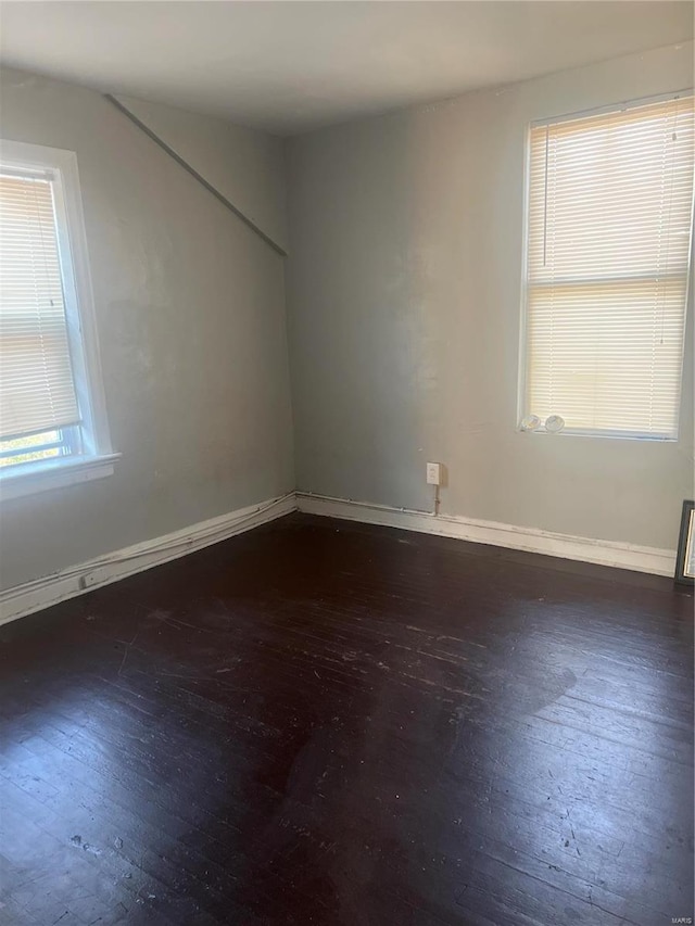 empty room with dark wood-type flooring