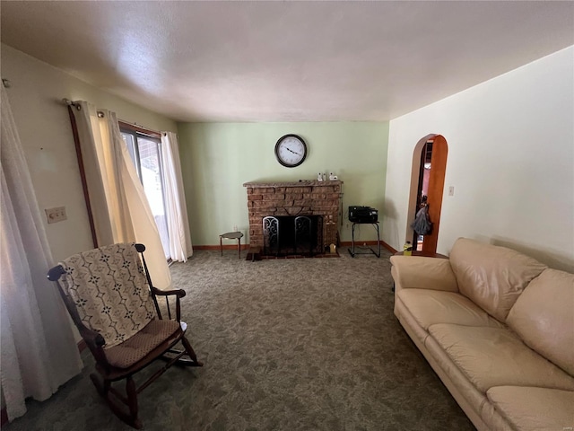 living room with a fireplace and dark carpet