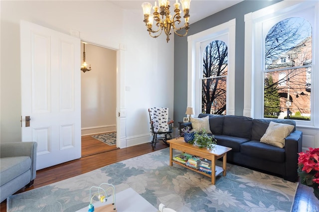 living room featuring wood-type flooring and a notable chandelier