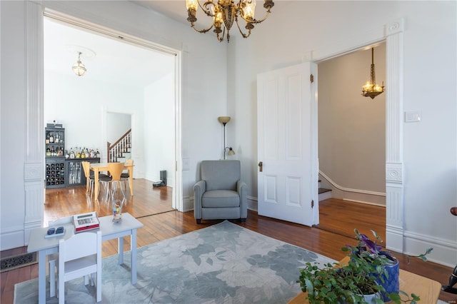 living area featuring a chandelier and wood-type flooring