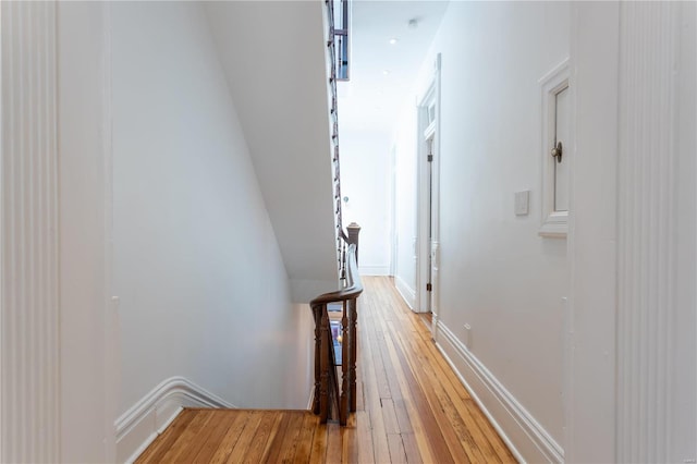 hall with hardwood / wood-style flooring