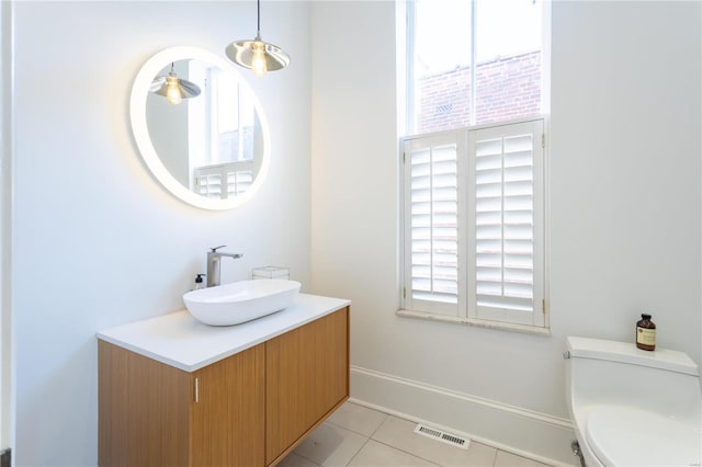 bathroom with tile patterned floors, vanity, and toilet