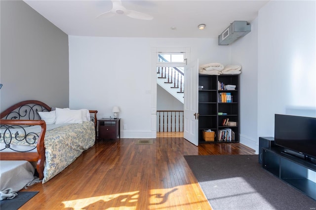 bedroom with ceiling fan and dark hardwood / wood-style floors