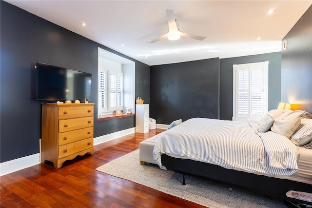 bedroom with dark hardwood / wood-style flooring and ceiling fan