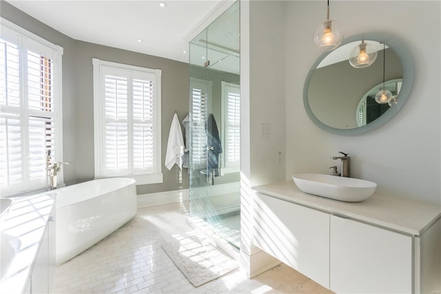 bathroom featuring tile patterned flooring, vanity, and a tub