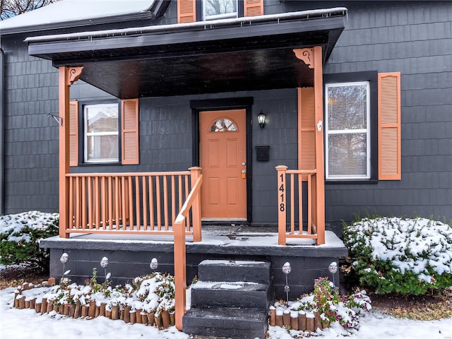 view of snow covered property entrance