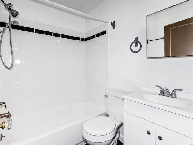 full bathroom with vanity, tiled shower / bath combo, and toilet