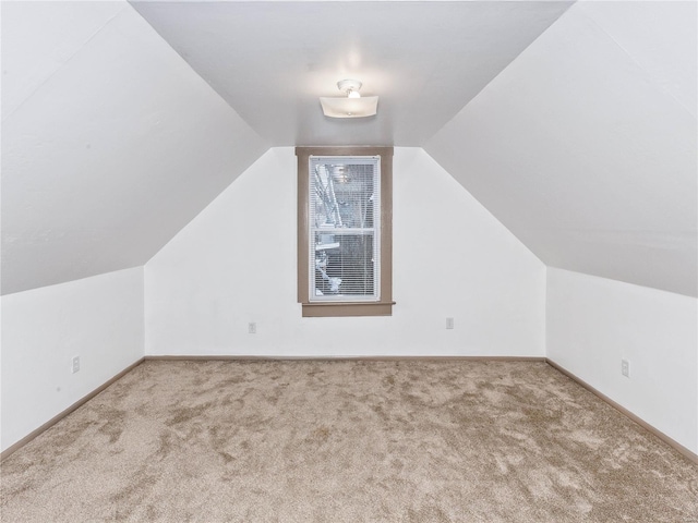 bonus room with carpet flooring and vaulted ceiling