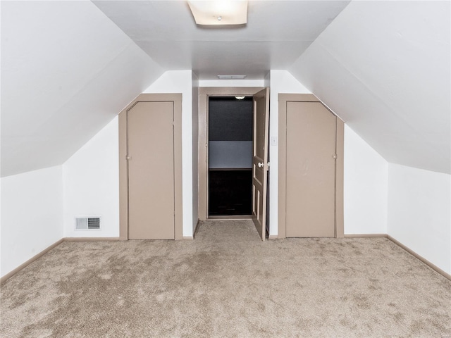 bonus room featuring light carpet and lofted ceiling