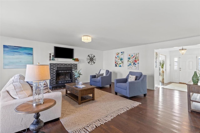 living room with hardwood / wood-style floors and a brick fireplace