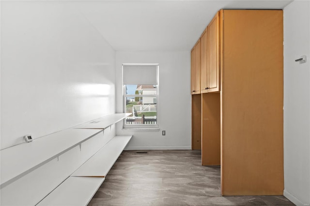 clothes washing area featuring dark hardwood / wood-style flooring