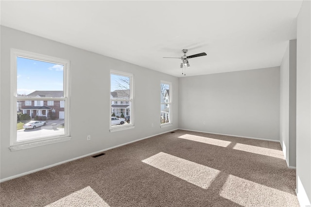 empty room featuring carpet floors and ceiling fan