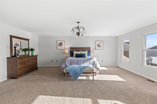 bedroom with a notable chandelier and light colored carpet