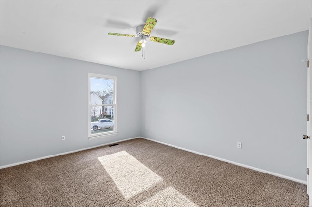 spare room with carpet flooring and ceiling fan