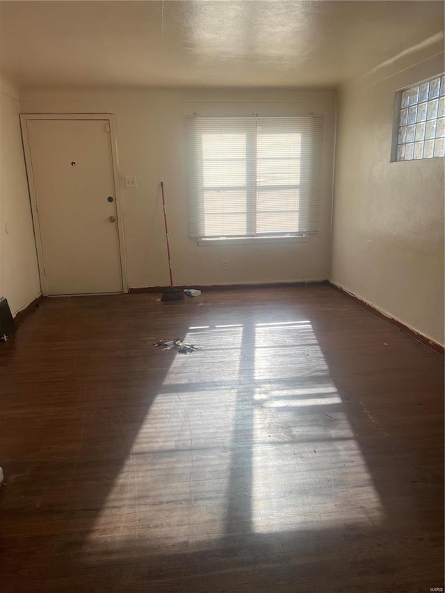 spare room with dark hardwood / wood-style flooring