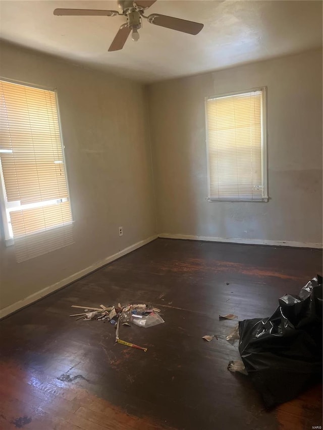 spare room featuring ceiling fan and dark hardwood / wood-style flooring