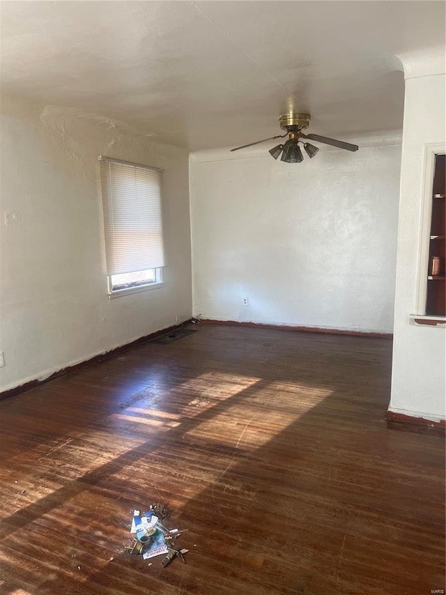 spare room featuring dark hardwood / wood-style floors and ceiling fan