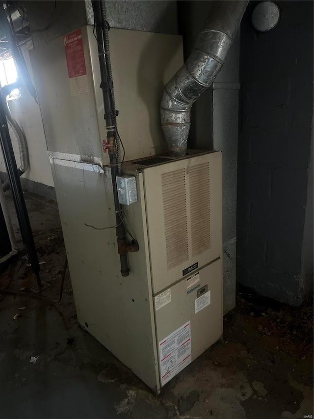 utility room featuring heating unit