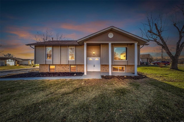 bi-level home featuring a yard